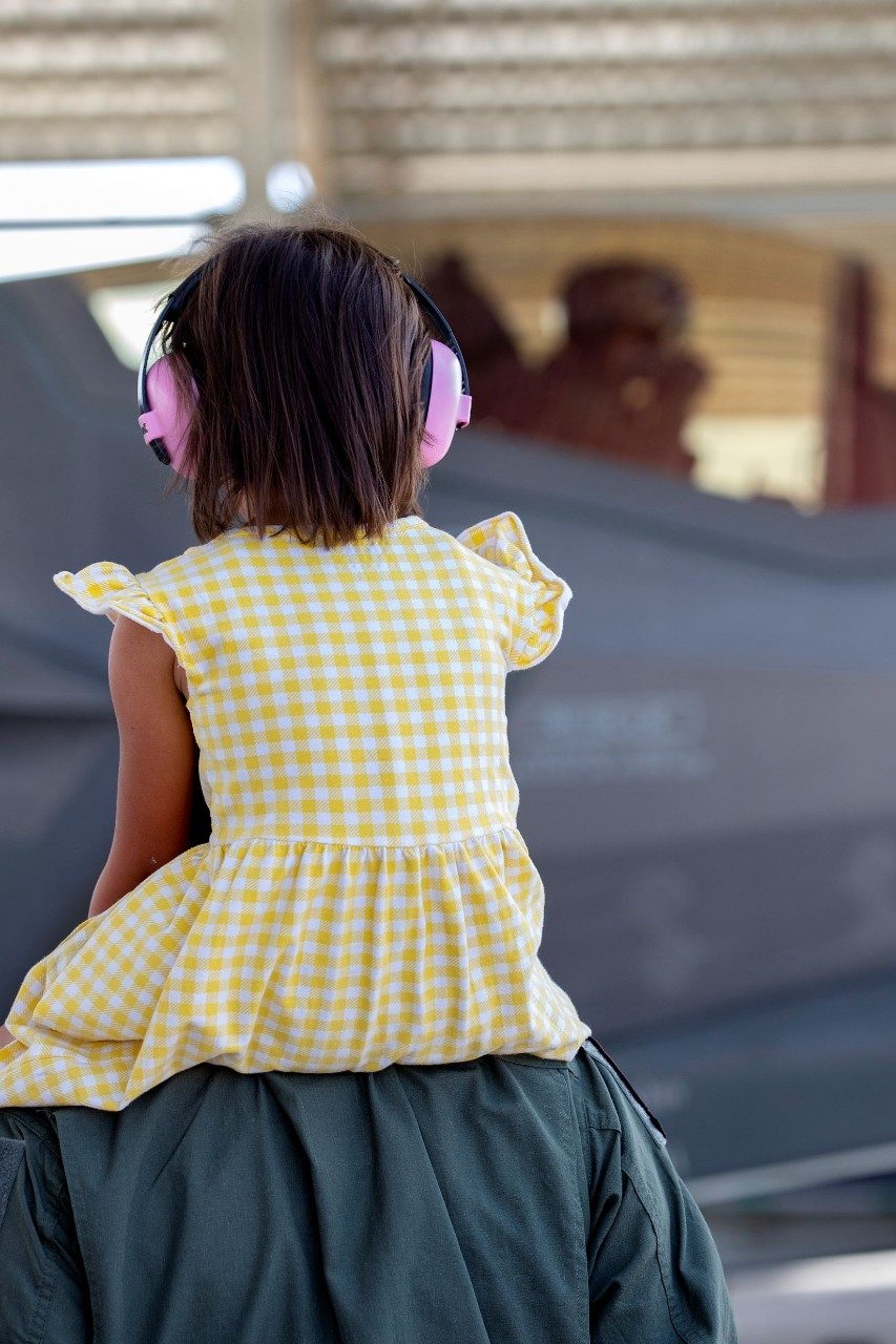 child watching fighter jet